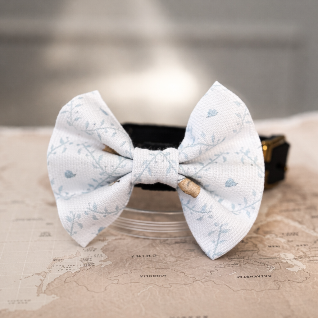 White Easter dog bow with bunnies pattern on a world map background.