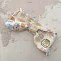 Dog bow bandana with breakfast-themed motifs on a world map background.