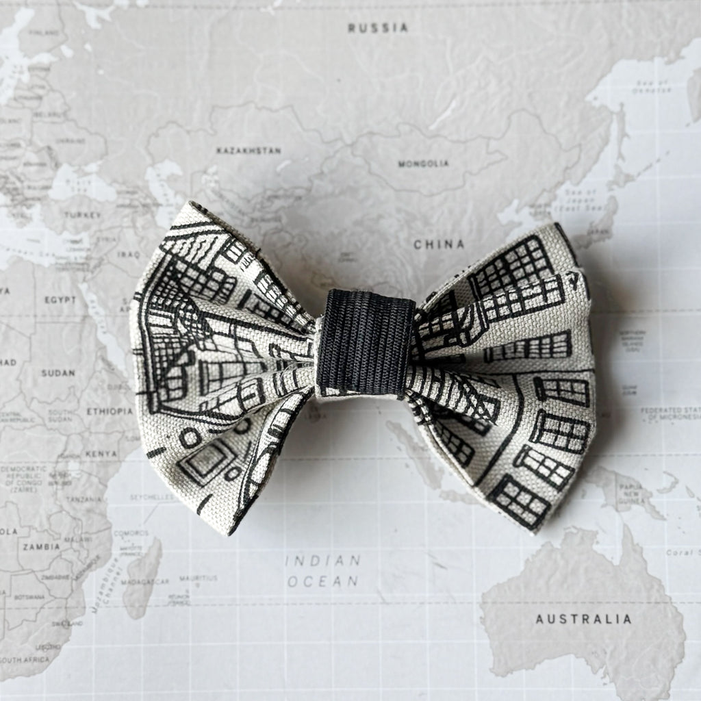 Back side of a  dog bow with Amsterdam Canal Houses print on a world map background.