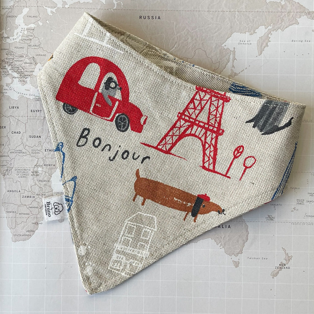 Dog bandana with Paris motifs on a world map background.
