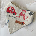 Dog bandana with Paris motifs on a world map background.