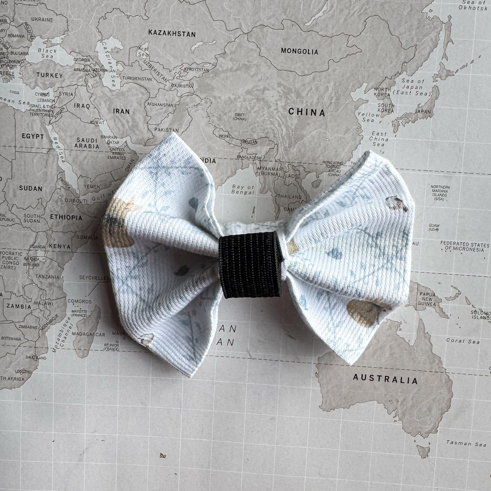 Back of the white Easter dog bow with the elastic loop.