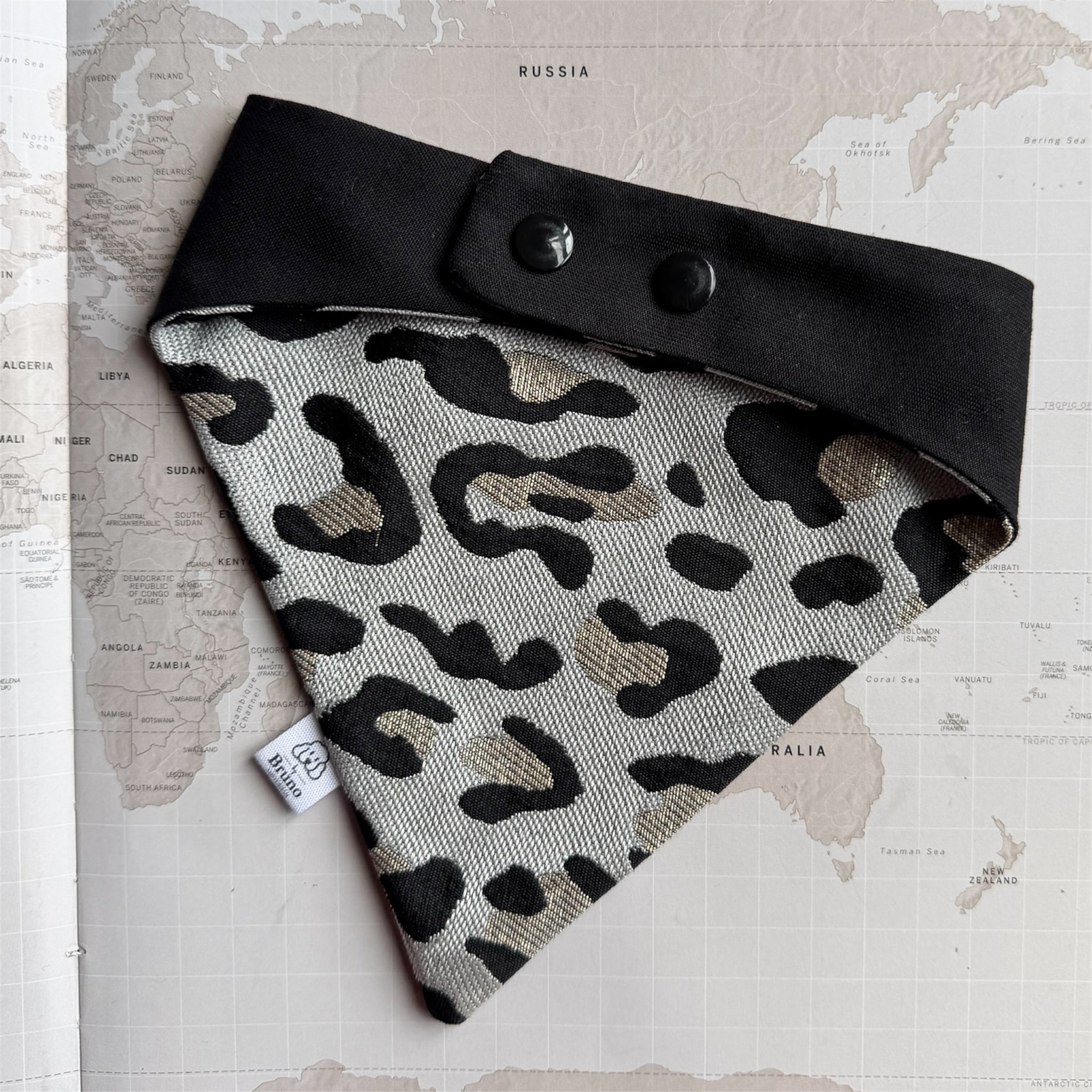 Leopard dog bandana with black buttons.