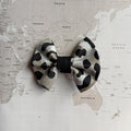 Leopard dog bow on a world map background.