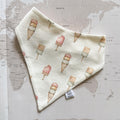 Handmade beige dog bandanna with pastel ice creams on a world map background.