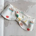 White handmade dog bowdana with summer symbols like crabs, palm trees, bananas on a world map background.